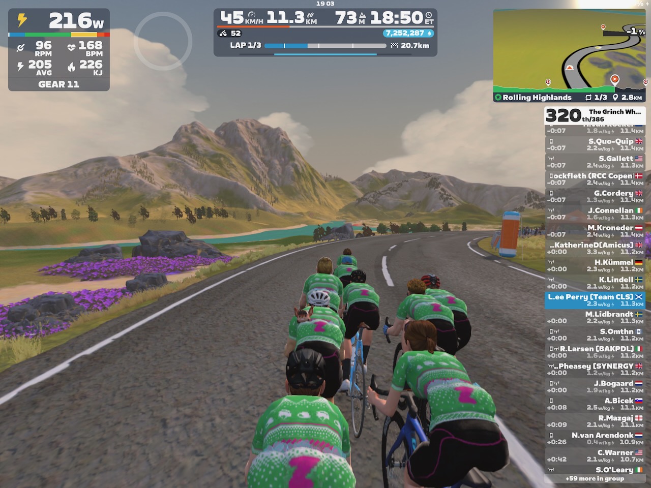 Riders avatars riding past hills resembling the Monadhliath range on Zwift's Scotland world.